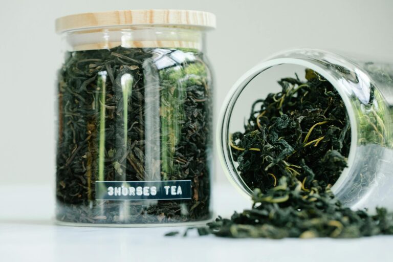 Herbal tea leaves in glass jars showcasing natural ingredients and traditional style.